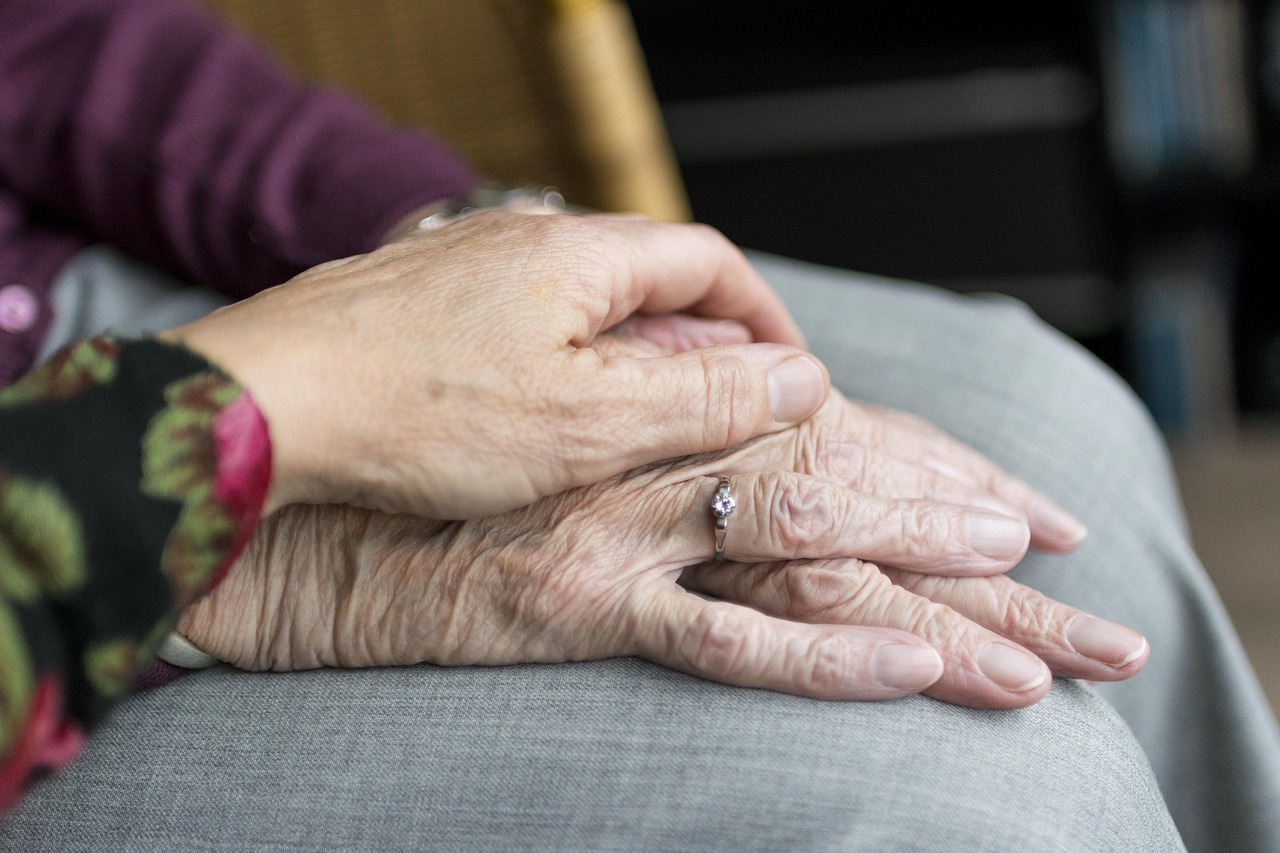 older couple holding hands