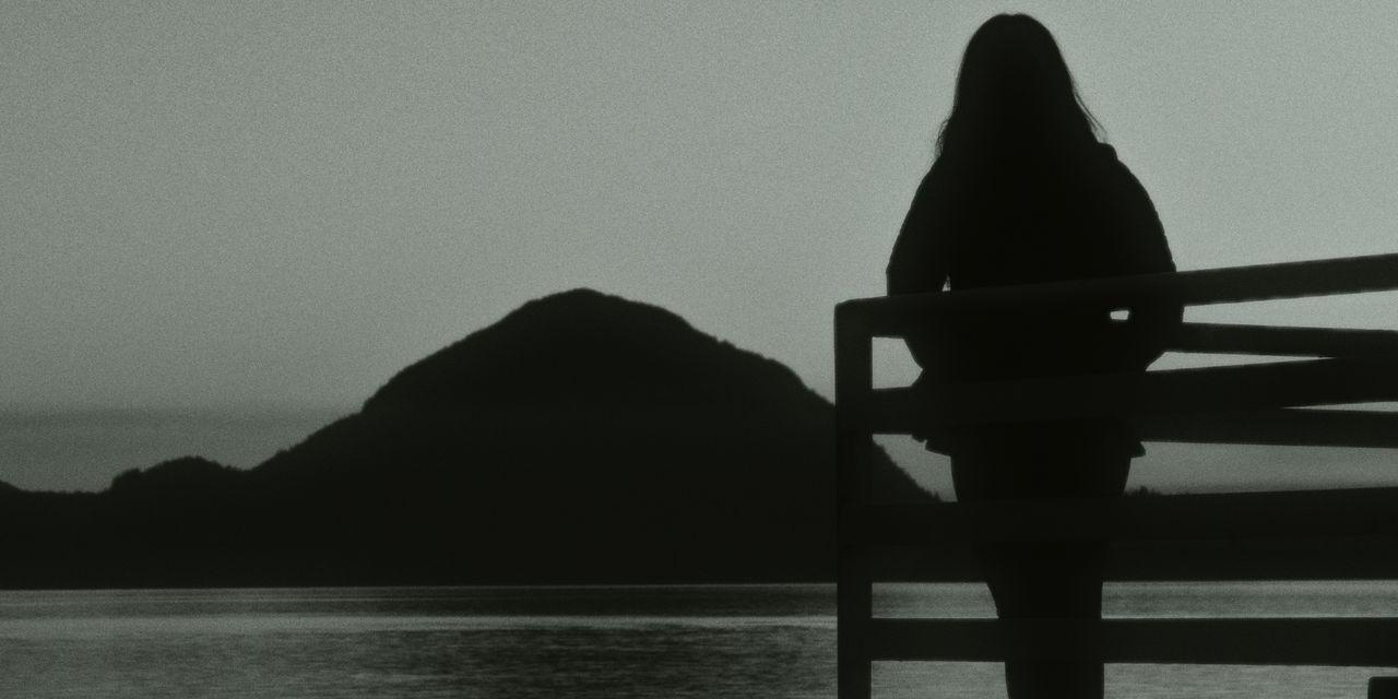 woman looking out on water